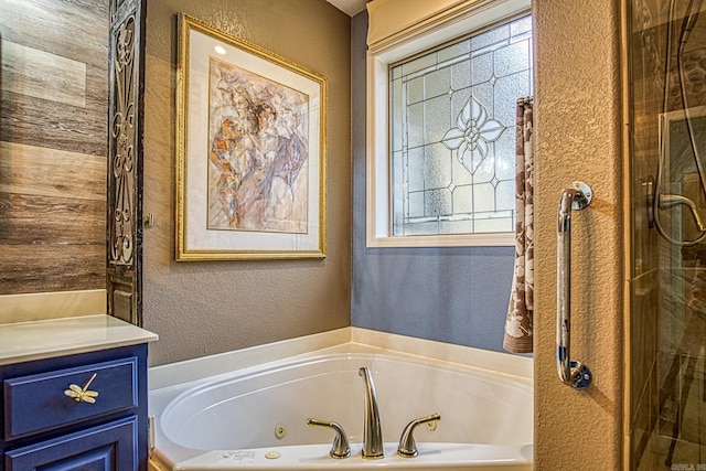 bathroom featuring vanity and independent shower and bath