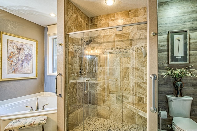 bathroom featuring plus walk in shower, a textured ceiling, and toilet