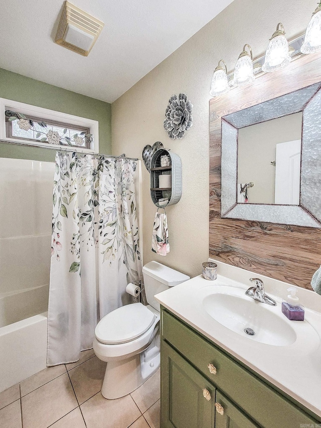 full bathroom featuring tile patterned floors, vanity, toilet, and shower / tub combo