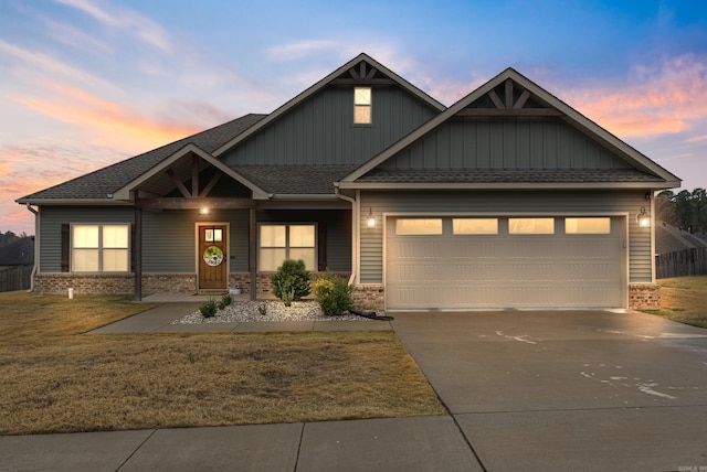 craftsman house featuring a yard and a garage