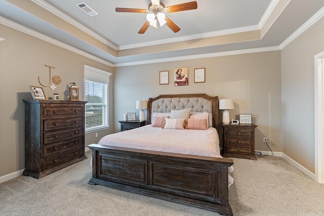 bedroom featuring a raised ceiling, ceiling fan, light carpet, and ornamental molding