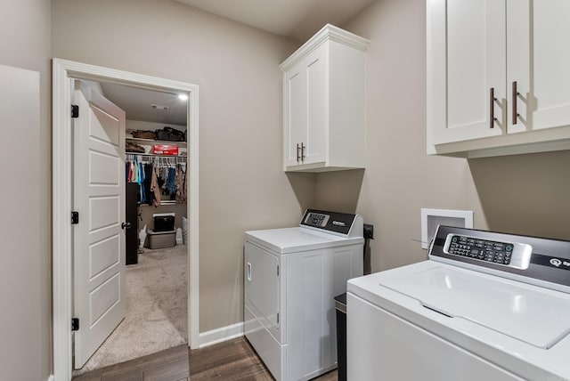 washroom featuring cabinets, dark hardwood / wood-style flooring, and washing machine and dryer