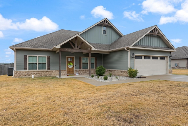 craftsman house with a garage, central air condition unit, and a front yard