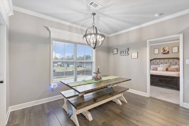 dining area with dark hardwood / wood-style flooring, ornamental molding, and a notable chandelier