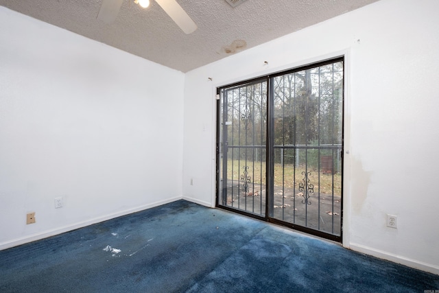 carpeted spare room with a textured ceiling and ceiling fan