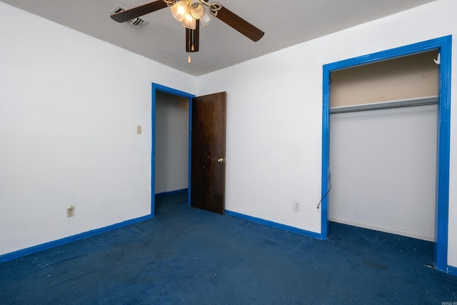 unfurnished bedroom with ceiling fan, a closet, dark carpet, and a textured ceiling