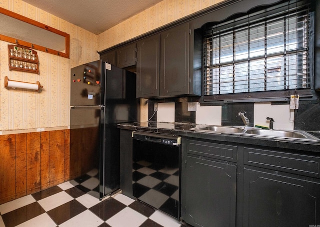 kitchen featuring wood walls, black appliances, sink, wine cooler, and a textured ceiling