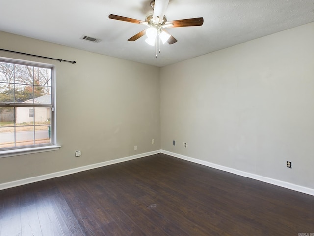 empty room with dark hardwood / wood-style flooring and ceiling fan