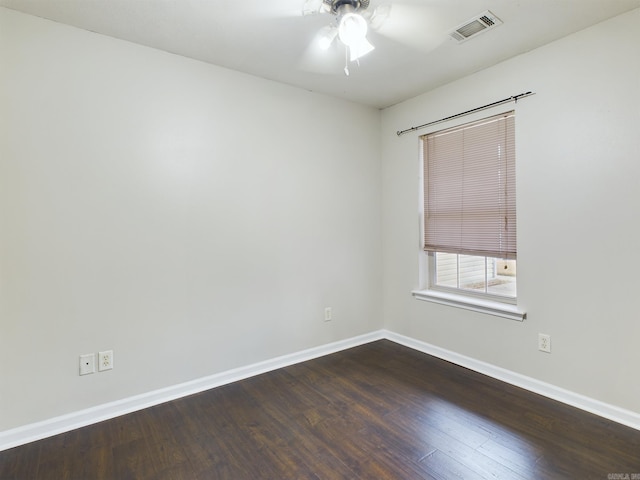 empty room with ceiling fan and dark wood-type flooring