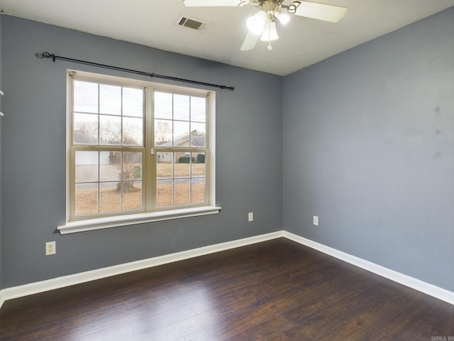 empty room featuring ceiling fan and dark wood-type flooring