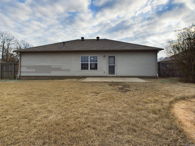 rear view of house featuring a patio area and a lawn