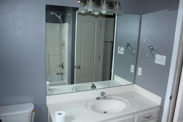 full bathroom with vanity, toilet, and  shower combination