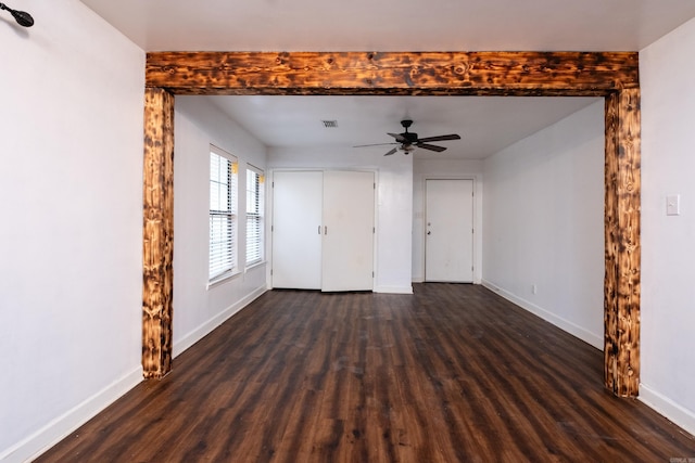 unfurnished living room with dark hardwood / wood-style flooring and ceiling fan