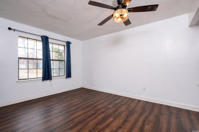 spare room with a textured ceiling, dark hardwood / wood-style floors, and ceiling fan