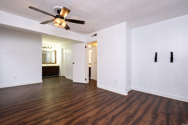 unfurnished room featuring ceiling fan, dark hardwood / wood-style flooring, and sink