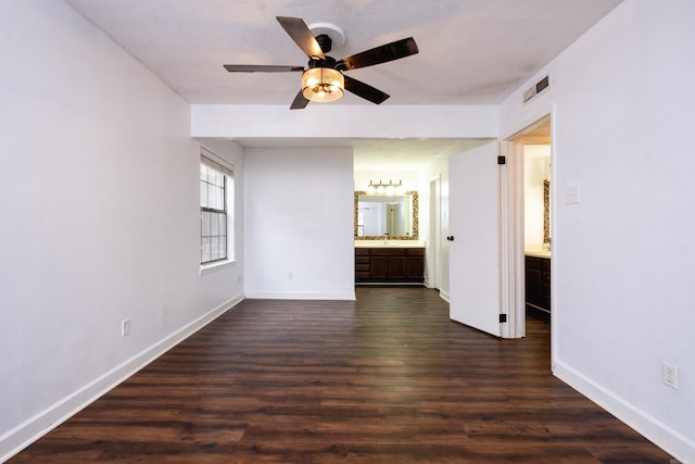 unfurnished room featuring ceiling fan and dark hardwood / wood-style floors