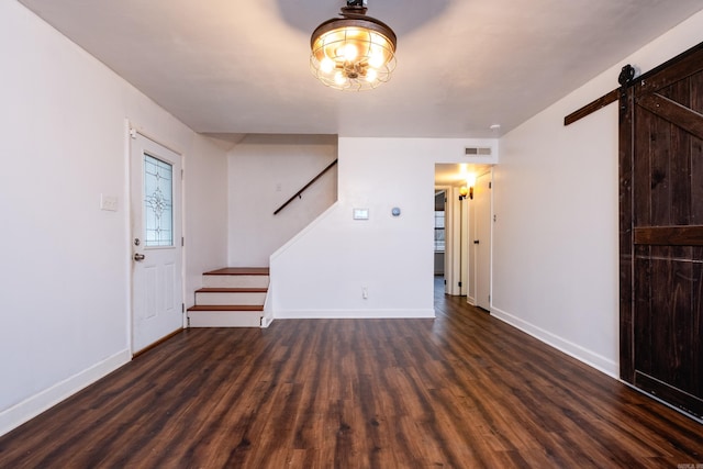 interior space featuring dark hardwood / wood-style flooring and a barn door