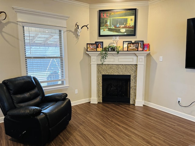 sitting room with a high end fireplace, dark hardwood / wood-style flooring, a wealth of natural light, and crown molding