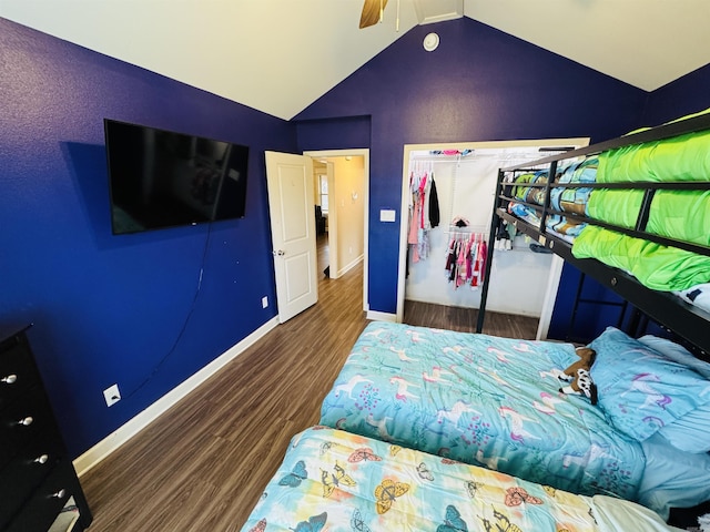 bedroom with lofted ceiling, a closet, dark wood-type flooring, and ceiling fan