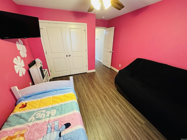 bedroom featuring wood-type flooring, a closet, and ceiling fan