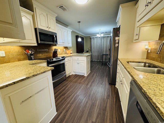 kitchen featuring kitchen peninsula, stainless steel appliances, sink, pendant lighting, and dark hardwood / wood-style floors