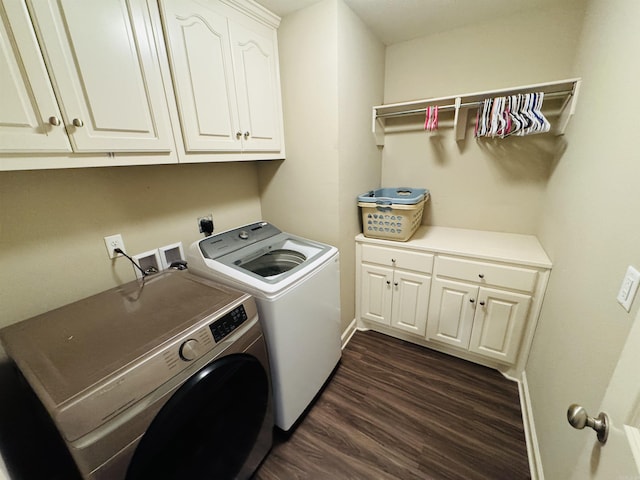 washroom featuring dark hardwood / wood-style flooring, cabinets, and independent washer and dryer