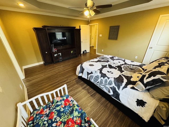 bedroom featuring ceiling fan, dark hardwood / wood-style flooring, and crown molding