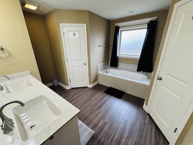 bathroom with vanity, hardwood / wood-style flooring, and a bathing tub