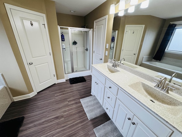 bathroom featuring separate shower and tub, vanity, and hardwood / wood-style flooring