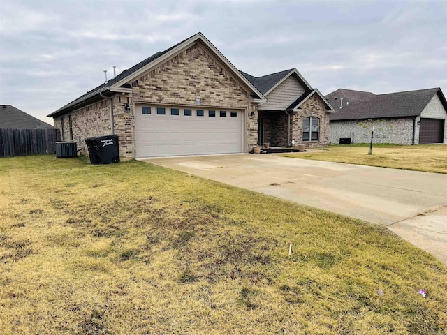 view of front of property with central air condition unit, a front lawn, and a garage