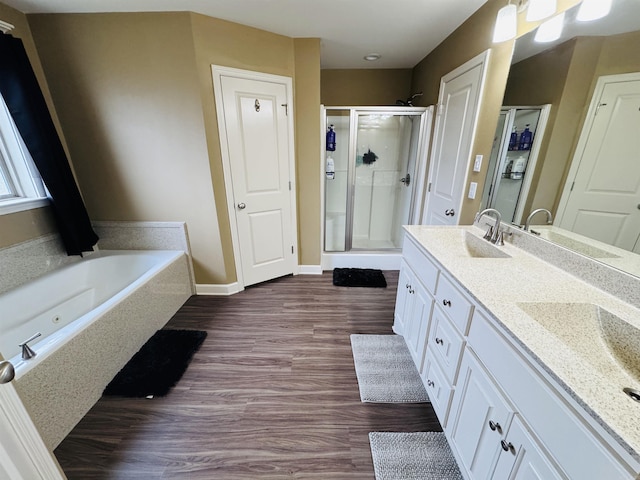 bathroom featuring vanity, independent shower and bath, and hardwood / wood-style flooring