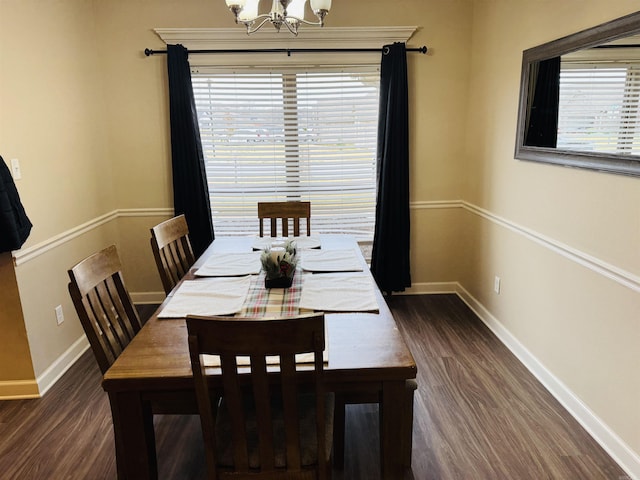 dining space with a notable chandelier and dark hardwood / wood-style floors