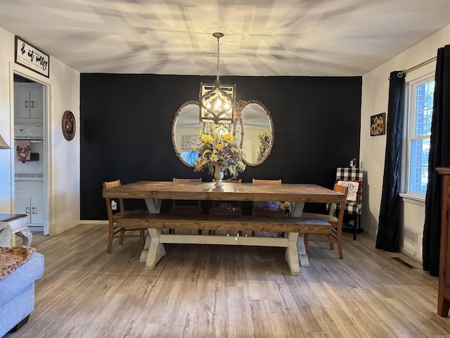 dining area featuring a notable chandelier and wood-type flooring