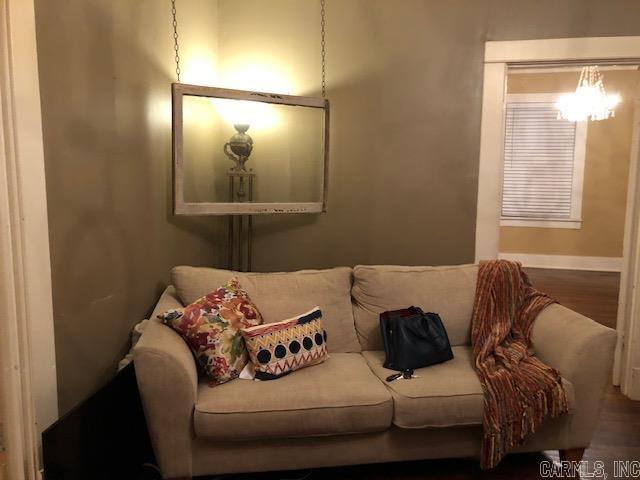 living room featuring hardwood / wood-style floors and an inviting chandelier