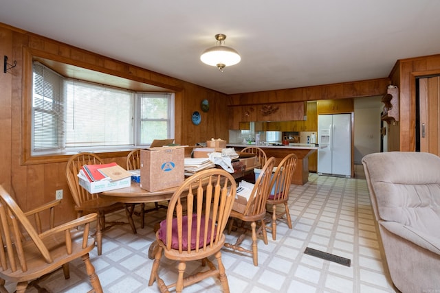 dining area with wooden walls