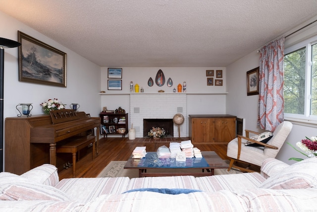 living room featuring a fireplace, hardwood / wood-style floors, and a textured ceiling