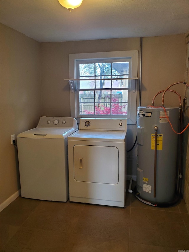 washroom featuring electric water heater and washer and dryer