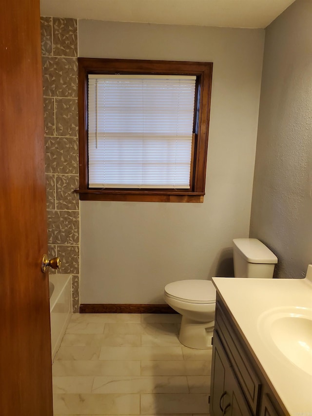 full bathroom with bathing tub / shower combination, vanity, and toilet