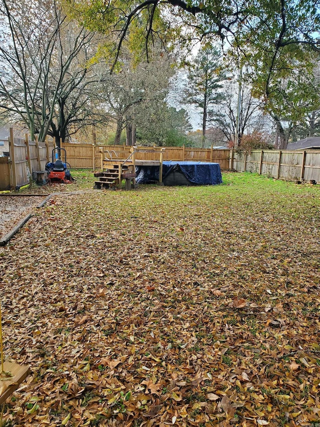 view of yard with a covered pool