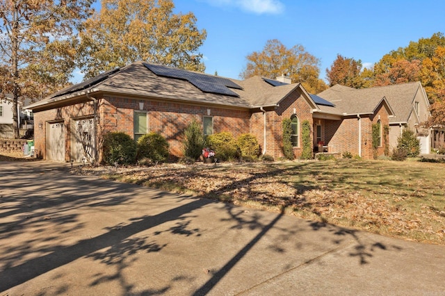 view of front of house featuring a garage and solar panels