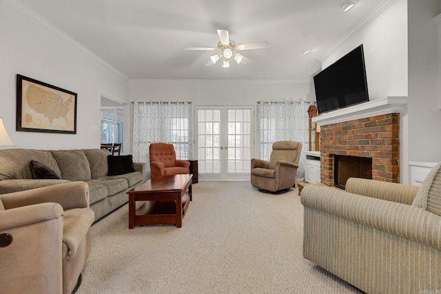 carpeted living room with a fireplace, crown molding, french doors, and ceiling fan