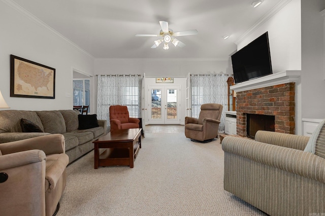 living room with crown molding, french doors, ceiling fan, and a brick fireplace