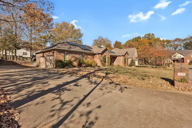 view of front of house with solar panels and a garage