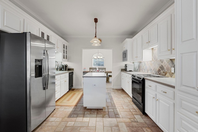 kitchen featuring white cabinets, pendant lighting, a center island, and black appliances