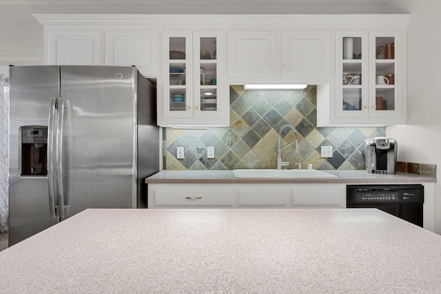 kitchen with white cabinets, stainless steel fridge, dishwasher, and sink