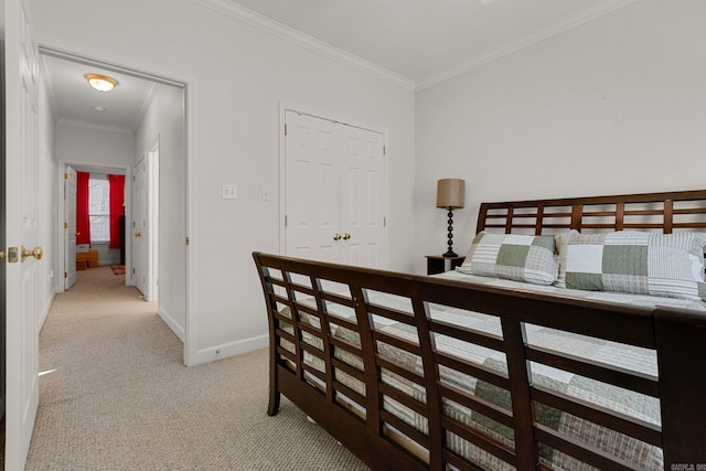 carpeted bedroom featuring a closet and ornamental molding