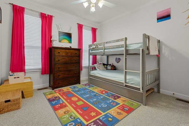 bedroom featuring carpet flooring, ceiling fan, and crown molding