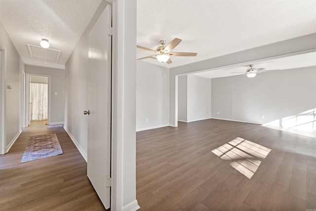 corridor with dark hardwood / wood-style flooring and a textured ceiling