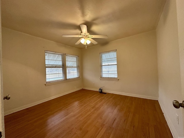 unfurnished room featuring ceiling fan, hardwood / wood-style floors, and a healthy amount of sunlight