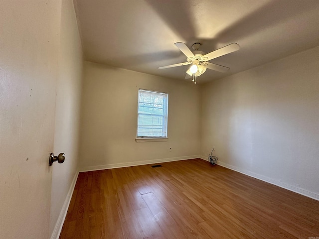 spare room featuring hardwood / wood-style floors and ceiling fan